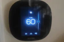 Thumbnail for Ecobee thermostat set to 60 degrees Fahrenheit with 54% humidity and cooling mode active on a wall.