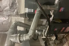 Thumbnail for Metal HVAC ductwork and furnace installation in a basement with insulated walls and pipes.