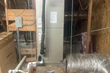 Thumbnail for Carrier HVAC unit installed in an attic with surrounding ductwork, tools, and building materials visible.