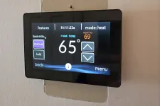 Thumbnail for HVAC Thermostat Repair in Atlanta 30327 by The Air Company.  Digital thermostat mounted on wall showing current room temperature 65 degrees and heating set to 69 degrees Fahrenheit.