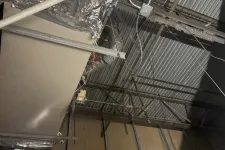 Thumbnail for Ceiling area of industrial building showing metal framework, ductwork, and electrical wiring under installation.