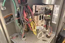 Thumbnail for Residential AC Heat Repair in Marietta 30068 by The Air Company of GA.  Inside view of a circuit board with colorful electrical wires in a metal enclosure warning of electric shock hazards.