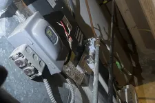 Thumbnail for View of an HVAC system with electrical components, pipes, and wiring in a basement or utility room.