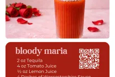Thumbnail for Bloody Maria cocktail in a salted rim glass garnished with lime wedge and green olive on a pink background with red roses.