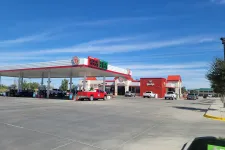 Thumbnail for a gas station with cars parked at the gas station