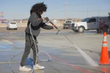 Thumbnail for a person using a hose to water a road