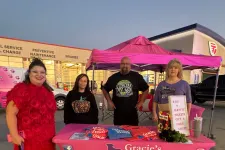 Thumbnail for a group of people standing outside a food stand