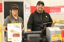 Thumbnail for Marcos Curiel et al. standing next to a food cart