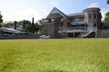 Thumbnail for a large building with a lawn in front of it
