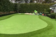 Thumbnail for a large green lawn with a few people on it