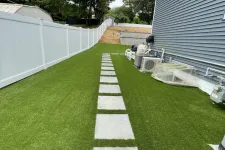 Thumbnail for a green lawn with a white fence