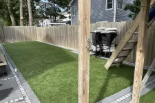 Thumbnail for a backyard with a grill and a wood fence