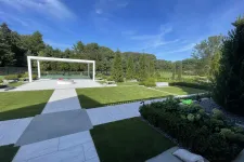 Thumbnail for a large green lawn with a white gazebo and trees