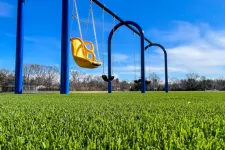 Thumbnail for a swing set in a field