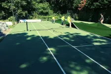 Thumbnail for a group of people play tennis