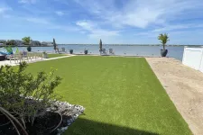 Thumbnail for a grassy area with a body of water in the background