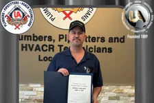 Thumbnail for Man holding a certificate celebrating 25 years of membership at Plumbers, Pipefitters, and HVACR Technicians union.