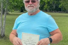 Thumbnail for Ken Bates holding a certificate