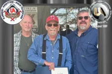 Thumbnail for Three men standing together, one holding a certificate celebrating George A. Jennings' 40 years of membership.