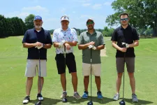 Thumbnail for a group of men posing for a photo on a golf course