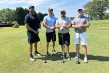 Thumbnail for a group of men posing for a picture on a golf course
