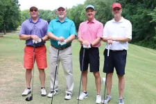 Thumbnail for a group of men posing for a photo on a golf course