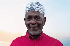 Thumbnail for Man in red ExxonMobil shirt and Texans cap holding a Forty-Five-Year Membership Certificate dated January 6, 2026.