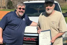 Thumbnail for a couple of men holding a certificate