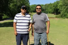 Thumbnail for two men standing on a golf course