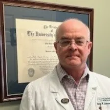 a man wearing a white coat.