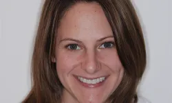 Thumbnail control image for Smiling woman with light brown hair and green eyes against a plain white background.
