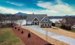 Thumbnail control image for a house with a driveway and a dirt road with grass and trees