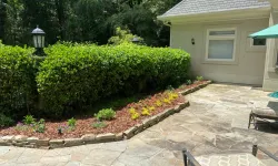 Thumbnail control image for a brick patio with bushes and a house in the background