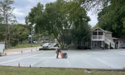 Thumbnail control image for a person walking a dog in a parking lot