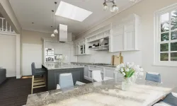 Thumbnail control image for a kitchen with white cabinets and a marble table with skylights