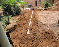 a dirt path with a building in the background