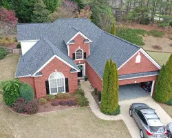 a house with a driveway and cars parked in front of it