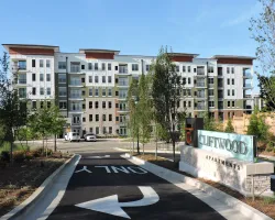 a building with trees and a parking lot