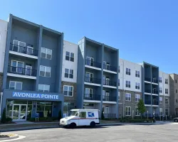 a white van parked in front of a building