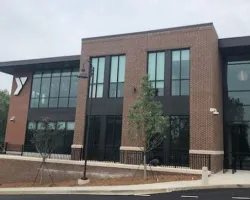 a building that has a sign on the side of a road