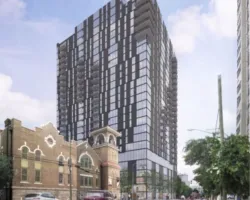 a tall building with a street and cars in front of it