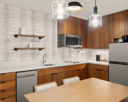 Guest Kitchen Walnut-Stained Cabinets and Quartz