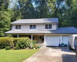 a house with a garage and trees