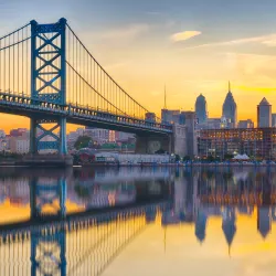 a bridge over water with a city in the background