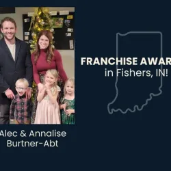 Family of five standing in front of a Christmas tree, announcing franchise awarded in Fishers, Indiana.