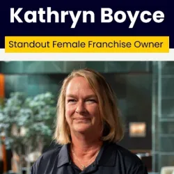 Portrait of Kathryn Boyce, standout female franchise owner, smiling with blurred indoor background.