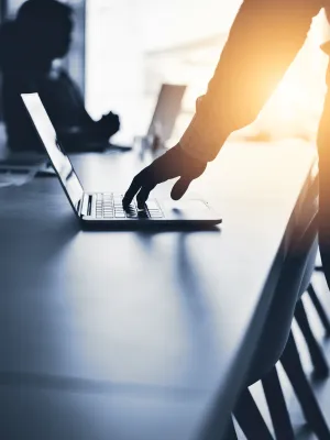a person's hand on a laptop