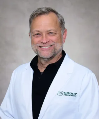 A portrait of Cameron Blevins, MD.