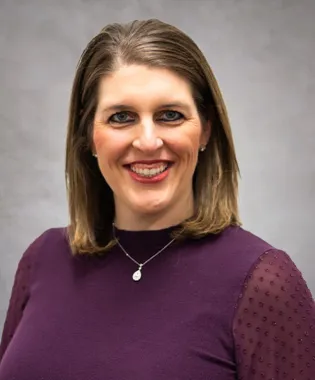 a woman smiling for the camera.