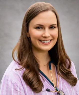 a woman with long hair smiling.